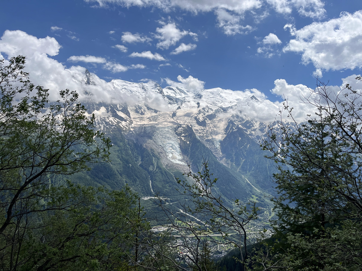 View to snow peaked mountains from trail in Chamonix